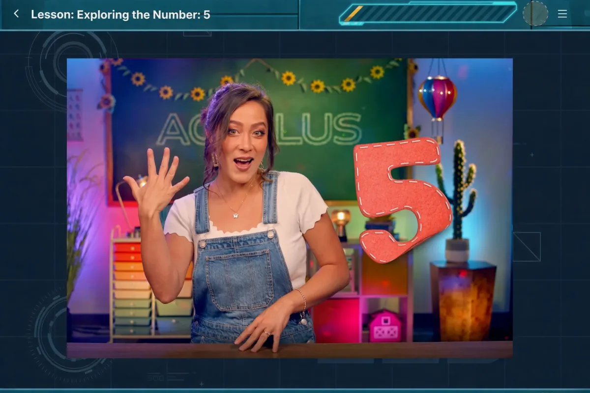 An Acellus video lesson, Exploring the Number 5: a teacher in a bright classroom set holds up five fingers beside a big stitched number 5